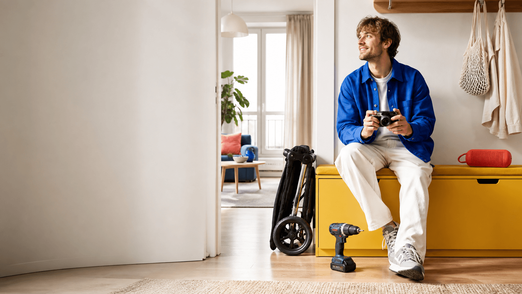 A renter preparing for a project with a camera, drill, stroller, and speaker